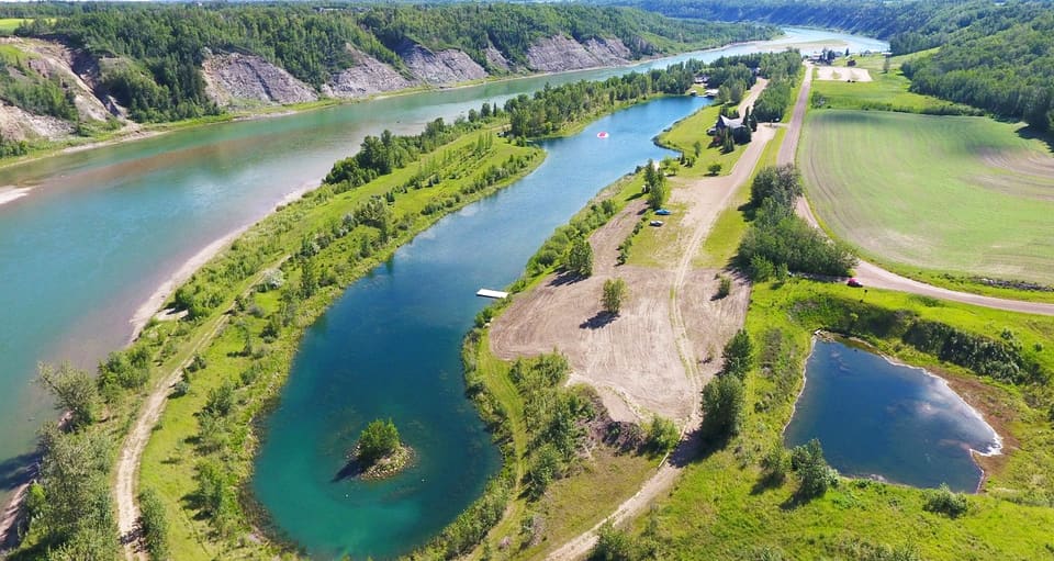 Aerial view of the full Shalom Park property: the 2,100-foot lake, clubhouse, and tree windbreaks