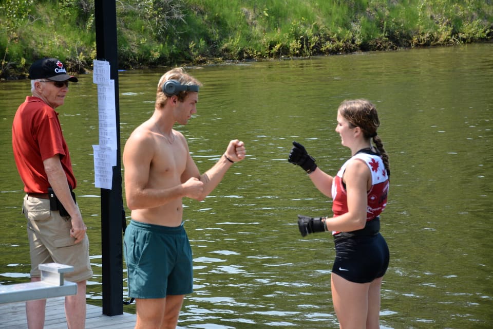 Coach Sean Kraus fist-bumping a young skier at the dock