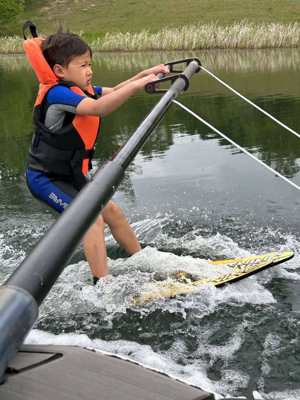 A young skier concentrating, up on skis